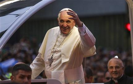 In this photo released by Prefeitura do Rio, Pope Francis waves to people from his popemobile in Rio de Janeiro, Monday, July 22, 2013. Pope Francis returned to his home continent for the first time as pontiff, embarking on a seven-day visit meant to fan the fervor of the faithful around the globe. (AP Photo/Raphael Lima, Prefeitura do Rio)