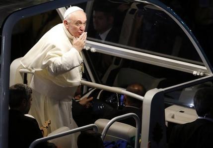 Pope Francis blows a kiss from his popemobile as he arrives for the Stations of the Cross event on Copacabana beach in Rio de Janeiro, Brazil, Friday, July 26, 2013. Also known as the Via Crucis and Via Dolorosa, the Stations of the Cross are built around reflections on Jesus' last steps leading up to his crucifixion and death. Francis started off the day, his fifth in Rio, by hearing confessions from a half-dozen young pilgrims in a park and met privately with juvenile detainees. (AP Photo/Silvia Izquierdo)