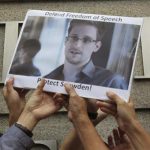 Protesters supporting Edward Snowden, a contractor at the National Security Agency (NSA), hold a photo of Snowden during a demonstration outside the U.S. Consulate in Hong Kong June 13, 2013. REUTERS/Bobby Yip