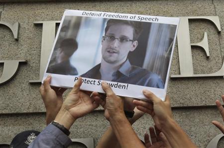 Protesters supporting Edward Snowden, a contractor at the National Security Agency (NSA), hold a photo of Snowden during a demonstration outside the U.S. Consulate in Hong Kong June 13, 2013. REUTERS/Bobby Yip