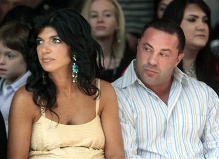 FILE - This Sept. 13, 2009 file photo originally released by Oral-B Pulsonic shows "Real Housewives of New Jersey" stars, Teresa Giudice, left, and her husband Joe Giudice at the Caravan Fashion Show sponsored by Oral-B Pulsonic in New York. Teresa and Giuseppe Joe Giudice were charged in a 39-count indictment handed up Monday, July 29, 2013, in Newark, N.J. The two are accused of submitting fraudulent mortgage and other loan applications from 2001 through 2008, a year before their show debuted on Bravo. Prosecutors say they made false claims about their employment status and salaries. (AP Photo/Oral-B Pulsonic, Gary He)