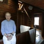 In this Friday, May 31, 2013 photo, Robert Post, 85, talks to The Associated Press about his home, in Mantoloking, N.J., which was flooded during Superstorm Sandy last year. Post has a pacemaker that needs to be checked once a month by phone, but the phone company refuses to restore the area's landlines after they were damaged by the storm. Verizon doesnt want to replace washed-away lines and waterlogged underground cables because phone lines are outdated, it says. Meanwhile, the company is offering a wireless device that can be plugged into home phones for service, but the system does not work with pacemakers or fax machines. (AP Photo/Julio Cortez)