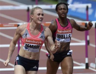 Sally Pearson (L) of Australia reacts next to third-placed Kellie Wells of the United States after winning the women's 100m hurdles at the London Diamond League 'Anniversary Games' athletics meeting in east London July 27, 2013. REUTERS/Paul Hackett