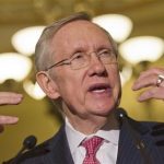 Senate majority leader Harry Reid gestures as he speaks to the media as lawmakers moved toward resolving their feud over filibusters of White House appointees on Capitol Hill in Washington, Tuesday, July 16, 2013. (AP Photo/Jacquelyn Martin)