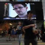 FILE - This June 23, 2013 file photo shows a TV screen shows a news report of Edward Snowden, a former CIA employee who leaked top-secret documents about sweeping U.S. surveillance programs, at a shopping mall in Hong Kong. President Barack Obama brushed aside sharp European criticism on Monday, suggesting all nations spy on each other, as the French and Germans expressed outrage over alleged U.S. eavesdropping on European Union diplomats. American analyst-turned-leaker Edward Snowden, believed to be stranded for the past week at Moscows international airport, applied for political asylum to remain in Russia. (AP Photo/Vincent Yu, File)