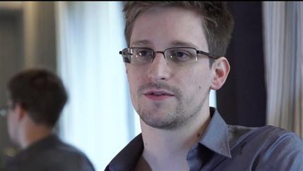 FILE - This Sunday, June 9, 2013 file photo provided by The Guardian Newspaper in London shows Edward Snowden, in Hong Kong. Russian state news agency said Wednesday, July 24, 2013 that US leaker Edward Snowden has been granted a document that allows him to leave the transit zone of a Moscow airport and enter Russia.  Snowden has applied for temporary asylum in Rusia last week after his attempts to leave the airport were thwarted. The United States wants him sent home to face prosecution for espionage.  (AP Photo/The Guardian, Glenn Greenwald and Laura Poitras, File)