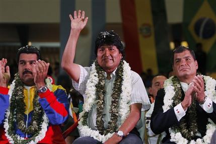 Venezuela's President Nicolas Maduro, left, Ecuador's President Rafael Correa, right, and Bolivia's President Evo Morales acknowledge supporters during a welcome ceremony for presidents attending an extraordinary meeting in Cochabamba, Bolivia, Thursday , July 4, 2013. Leaders of Uruguay, Ecuador, Surinam, Argentina and Venezuela are meeting in Bolivia Thursday in support of Morales, who said said Thursday that the rerouting of his plane in Europe, over suspicions that National Security Agency leaker Edward Snowden was on board was a plot by the U.S. to intimidate him and other Latin American leaders. (AP Photo/Juan Karita)