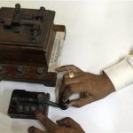 In this Friday, June 14, 2013 photo, a staff member of the central telegraph office shows an old telegraphic equipment which is no longer in use, in Mumbai, India. Just three decades ago - before reliable landlines were laid and well before the age of cheap cellphones arrived - the telegram was king across the vast Indian nation. On Monday, July 15, 2013, the state-run telecommunications company will send its final telegram, closing down a service that fast became a relic in an age of email, reliable land lines and ubiquitous cellphones. (AP Photo/Rajanish Kakade)