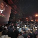 FILE - In this Wednesday, Feb. 2, 2011 file photo, anti-government protesters gathered in Tahrir (Liberation) Square, watch a screen showing U.S. President Barack Obama live on a TV broadcast from Washington, speaking about the situation in Egypt. U.S. officials say the Obama administration delivered pointed warnings Tuesday, July 2, 2013 to three main players in the latest crisis to grip Egypt as hundreds of thousands of protesters flooded Tahrir Square in Cairo to demand President Mohammed Morsis ouster over his hard-line Islamist policies. The powerful Egyptian military appeared poised to overthrow him. The administration stopped short of demanding that Morsi take specific steps, the officials said, and instead offered strong suggestions that are backed by billions of dollars in U.S. aid to ease the tensions. (AP Photo/Lefteris Pitarakis)
