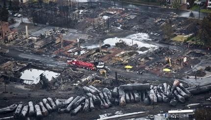 Workers comb through debris Tuesday, July 9, 2013, after a train derailed Saturday causing explosions of railway cars carrying crude oil in Lac-Megantic, Quebec. (AP Photo/The Canadian Press, Paul Chiasson)