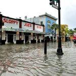 FILE - This Thursday, May 2, 2013 file photo shows flooding on Duval Street in Key West, Fla. after roughly five inches of rainfall. In many sea level projections for the coming century, the Keys, Miami and much of southern Florida partially sink beneath potential waves. (AP Photo/The Key West Citizen, Rob O'Neal)