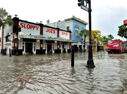 FILE - This Thursday, May 2, 2013 file photo shows flooding on Duval Street in Key West, Fla. after roughly five inches of rainfall. In many sea level projections for the coming century, the Keys, Miami and much of southern Florida partially sink beneath potential waves. (AP Photo/The Key West Citizen, Rob O'Neal)