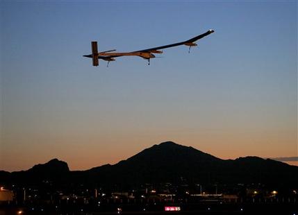 FILE - This May 22, 2013 file photo shows the Solar Impulse, piloted by André Borschberg, taking flight, at dawn, from Sky Harbor International Airport in Phoenix. The spindly no-fuel plane called Solar Impulse is scheduled to leave Washington Saturday early in the morning and arrive after midnight at New York's John F. Kennedy International Airport. It may silently buzz the Statue of Liberty on the way. The plane started its cross-country journey May 3 from San Francisco.  (AP Photo/Matt York)