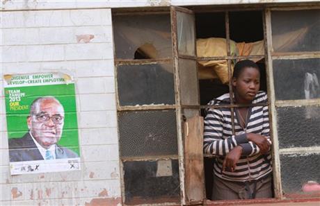A woman looks through her window in Mbare
