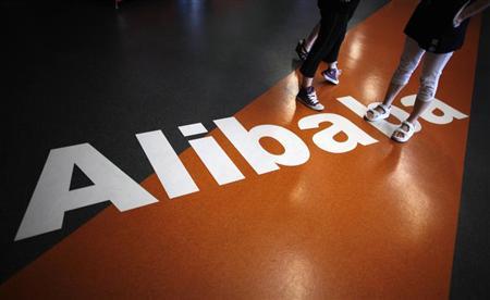 Employees stand on a logo of Alibaba (China) Technology Co. Ltd during a media tour organised by government officials at its headquarters on the outskirts of Hangzhou