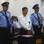 Disgraced Chinese politician Bo Xilai stands trial inside the court in Jinan, Shandong province