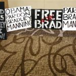 Placards from activists line the wall before a news conference by U.S. soldier Bradley Manning's defense attorney David Coombs in Hanover, Maryland