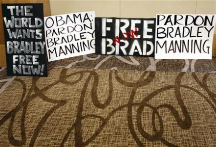 Placards from activists line the wall before a news conference by U.S. soldier Bradley Manning's defense attorney David Coombs in Hanover, Maryland