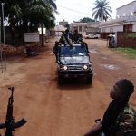 Armed fighters from the Seleka rebel alliance patrol the streets in pickup trucks to stop looting in Bangui