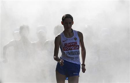 Lashmanova comes out of the cooling mist in the women's 20 km race walk final during the IAAF World Athletics Championships in Moscow