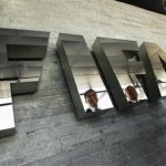 Garcia, Chairman of the investigatory chamber of the FIFA Ethics Committee and Eckert, Chairman of the adjudicatory chamber of the FIFA Ethics Committee are reflected on a logo at the Home of FIFA in Zurich