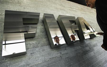 Garcia, Chairman of the investigatory chamber of the FIFA Ethics Committee and Eckert, Chairman of the adjudicatory chamber of the FIFA Ethics Committee are reflected on a logo at the Home of FIFA in Zurich