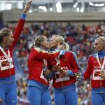 Gold medallists team Russia celebrate at the women's 4x400 metres relay victory ceremony during the IAAF World Athletics Championships at the Luzhniki stadium in Moscow