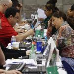 Home owners speak with Bank of America representatives as they try to get home loan modifications during the Neighborhood Assistance Corporation of America event in Phoenix
