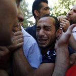Relatives mourn the deaths of two Palestinians at a hospital in Ramallah