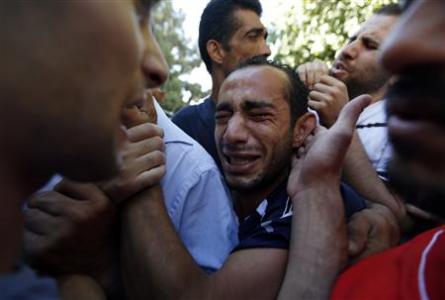 Relatives mourn the deaths of two Palestinians at a hospital in Ramallah