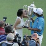 Jason Dufner, right, kisses the Wanamaker Trophy with his wife Amanda after winning the PGA Championship