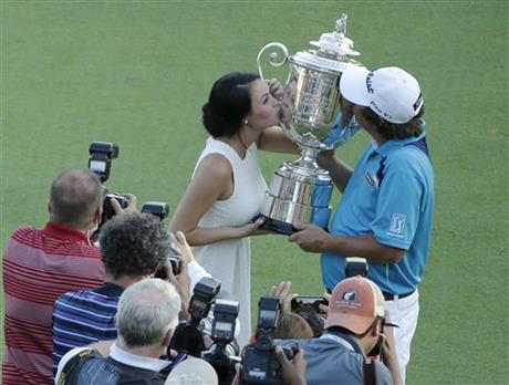 Jason Dufner, right, kisses the Wanamaker Trophy with his wife Amanda after winning the PGA Championship