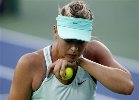 Sharapova of Russia reacts to her play against Stephens of the U.S. at the women's Cincinnati Open tennis tournament