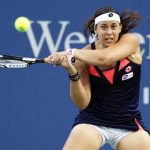Bartoli of France hits a return to Halep of Romania during their women's singles match at the Cincinnati Open tennis tournament