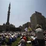 Members of the Muslim Brotherhood and supporters of ousted Egyptian President Mohamed Mursi attend Friday prayers at Ramses Square in Cairo