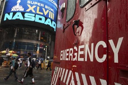 An emergency vehicle drives past the Nasdaq MarketSite in New York's Times Square