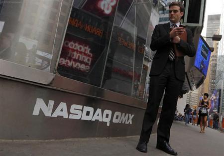 A man stands next to the Nasdaq MarketSite in New York