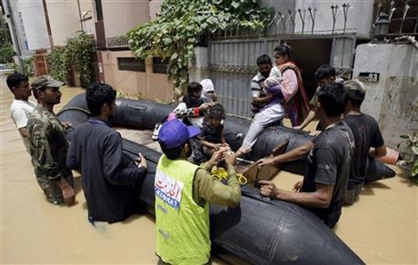 Pakistani soldiers rescue a family from an area flooded