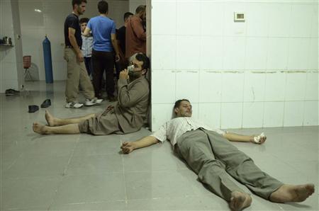 People, affected by what activists say was a gas attack, are treated at a medical center in the Damascus suburb of Saqba