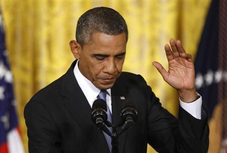 U.S. President Obama waves before departing a news conference in the East Room of the White House in Washington