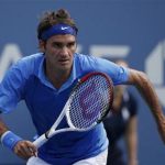 Federer of Switzerland chases down a return to Berlocq of Argentina at the U.S. Open tennis championships in New York