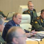 Vladimir Putin attends a conference at the main operation centre of the Russian armed forces in Moscow