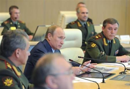 Vladimir Putin attends a conference at the main operation centre of the Russian armed forces in Moscow