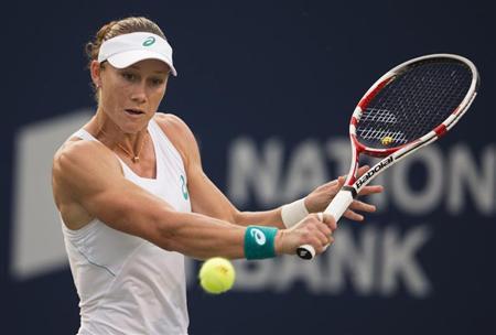 Stosur hits a return to Kvitova at the Rogers Cup tennis tournament in Toronto