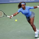 Serena Williams of the U.S. hits a return ball to Simona Halep of Romania in their quarterfinal round match at the Women's Cincinnati Open tennis tournament in Cincinnati