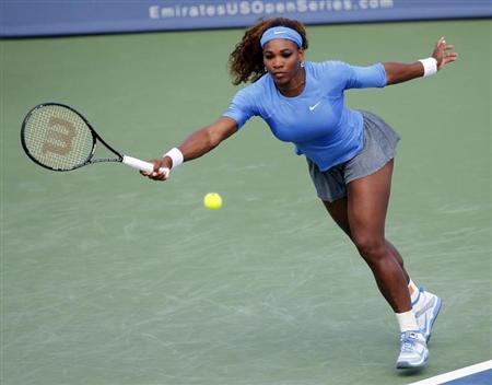 Serena Williams of the U.S. hits a return ball to Simona Halep of Romania in their quarterfinal round match at the Women's Cincinnati Open tennis tournament in Cincinnati