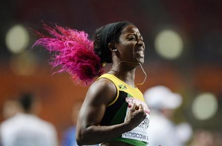 Shelly-Ann Fraser-Pryce of Jamaica celebrates winning the women's 100 metres final during the IAAF World Athletics Championships at the Luzhniki stadium in Moscow August 12, 2013. REUTERS/Dylan Martinez