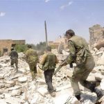 Forces loyal to Syria's President Assad carry their weapons during an operation in Aleppo
