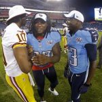 Tennessee Titans running back Chris Johnson (28) and wide receiver Kendall Wright (13) talk with Washington Redskins quarterback Robert Griffin III (10)