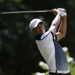 Tiger Woods of the U.S. tees off on the third hole during the third round of the 2013 PGA Championship golf tournament at Oak Hill Country Club in Rochester